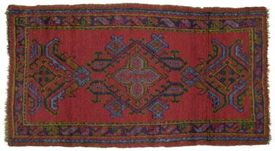 Appraisal: Oushak rug geometric central medallions on brick red field green