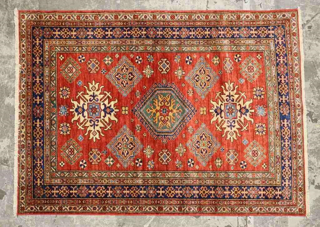 Appraisal: Persian rug Diamond medallion red and blue field Wear and