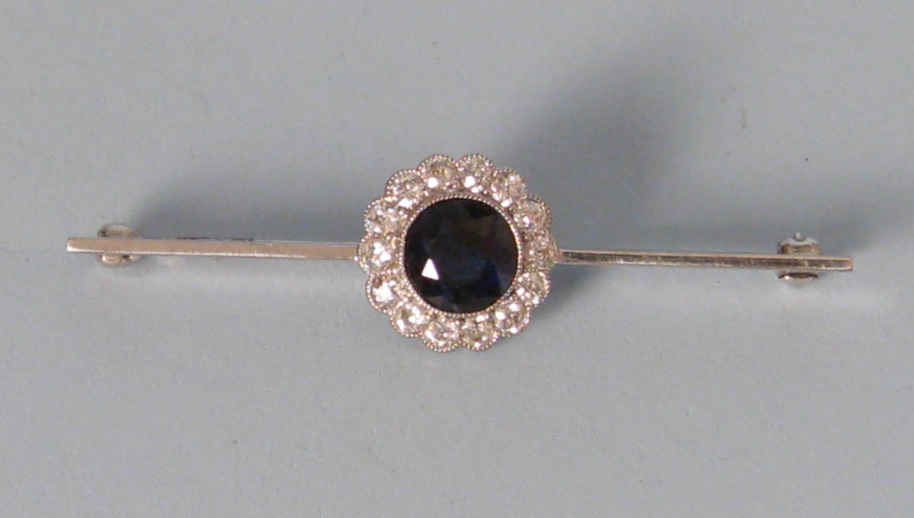 Appraisal: A Sapphire and Diamond Bar Brooch the circular-cut collet-set Sapphire