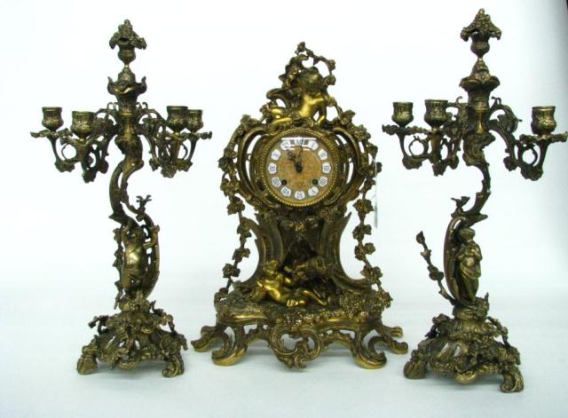 Appraisal: Three piece ornate French-style cast metal clock set with candelabra