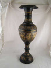 Appraisal: A large turned brass vase the black finish bright cut