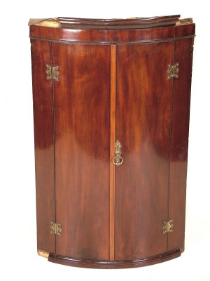 Appraisal: A George III bowfront mahogany corner cabinet circa the moulded