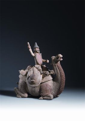 Appraisal: A Chinese pottery model of a recumbent camel with a