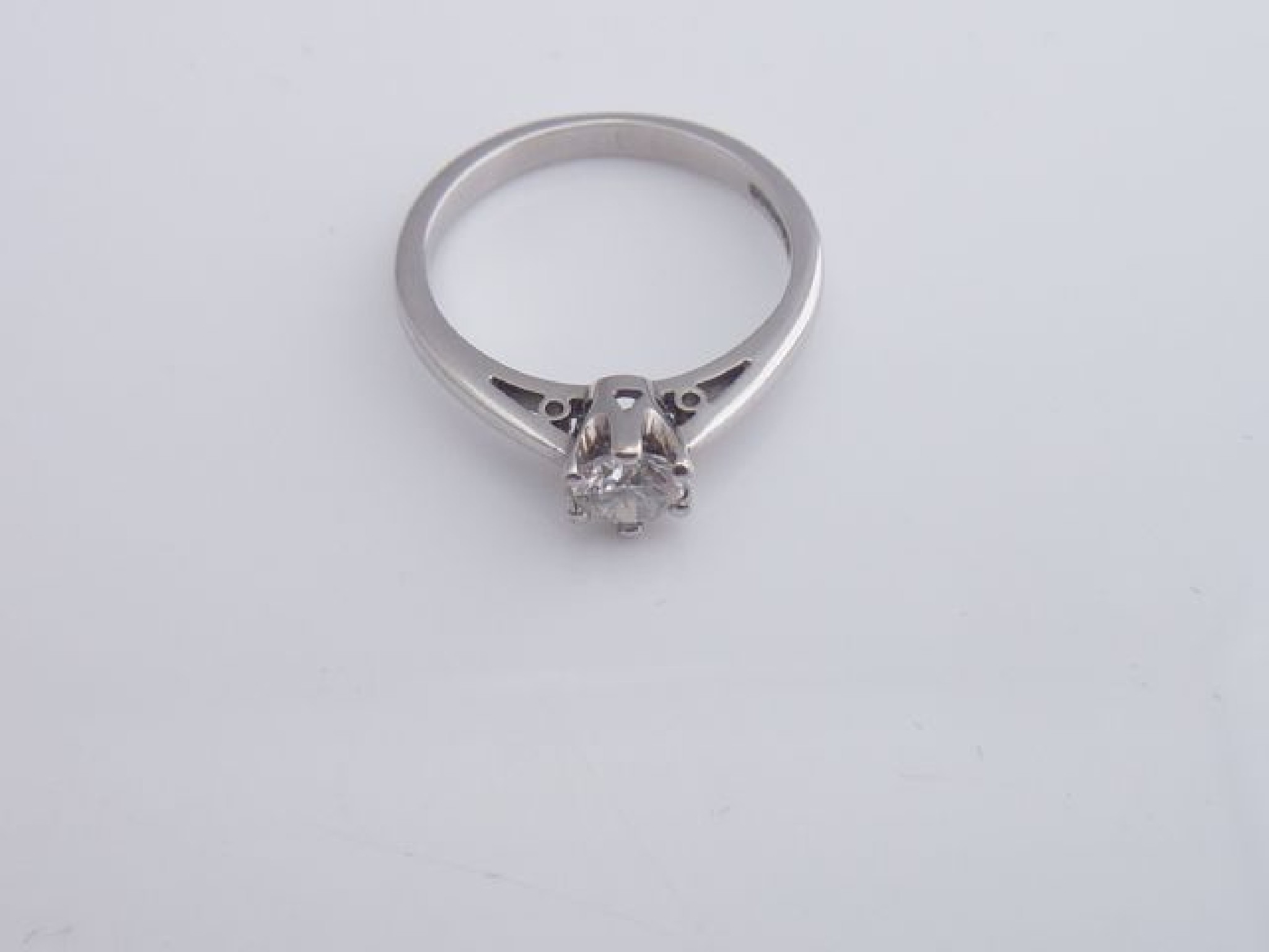 Appraisal: A solitaire diamond ring claw-set with a round brilliant-cut diamond