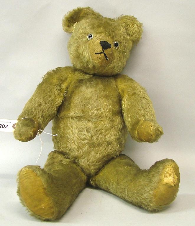 Appraisal: Mid th century Teddy bear with jointed limbs and blonde