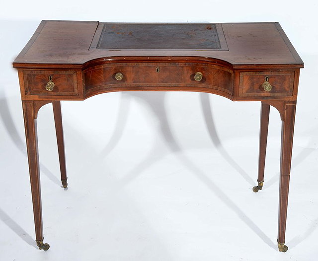 Appraisal: AN EDWARDIAN MAHOGANY AND ROSEWOOD CROSSBANDED DESK with shaped top