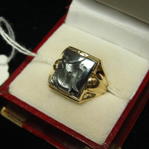 Appraisal: HEMATITE AND TEN KARAT GOLD RING centering a carved hematite