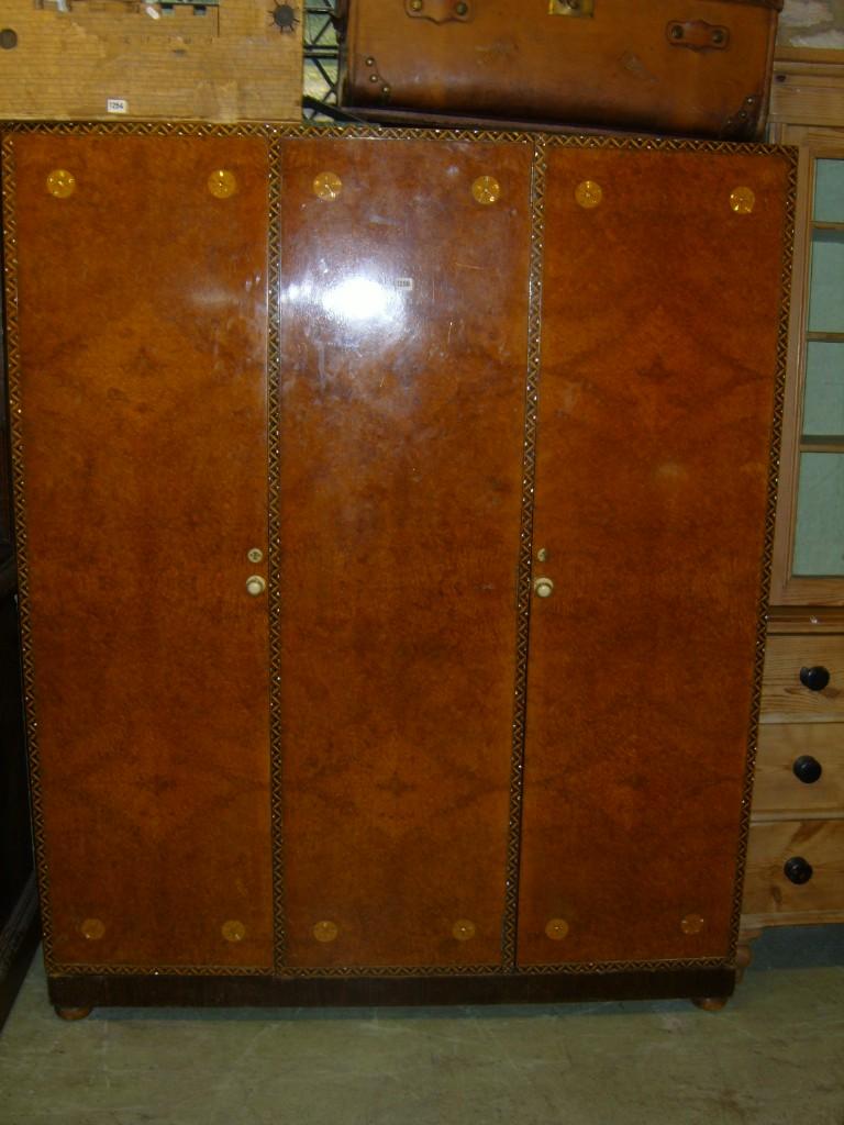 Appraisal: A Maple Co burr and figured walnut wardrobe enclosed by