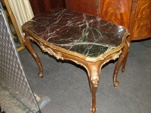 Appraisal: A gilt and gesso serpentine centre table with variegated marble