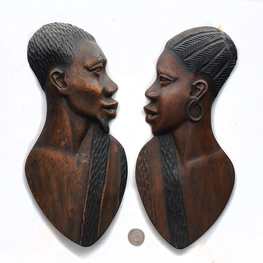 Appraisal: PAIR OF AFRICAN CARVED WOOD WALL PLAQUES Hand carved male