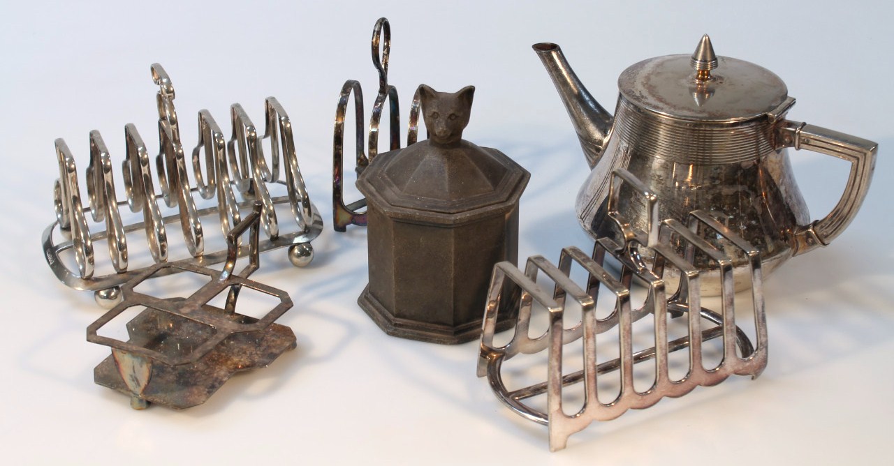 Appraisal: Three silver plated toast racks a silver plated bottle stand