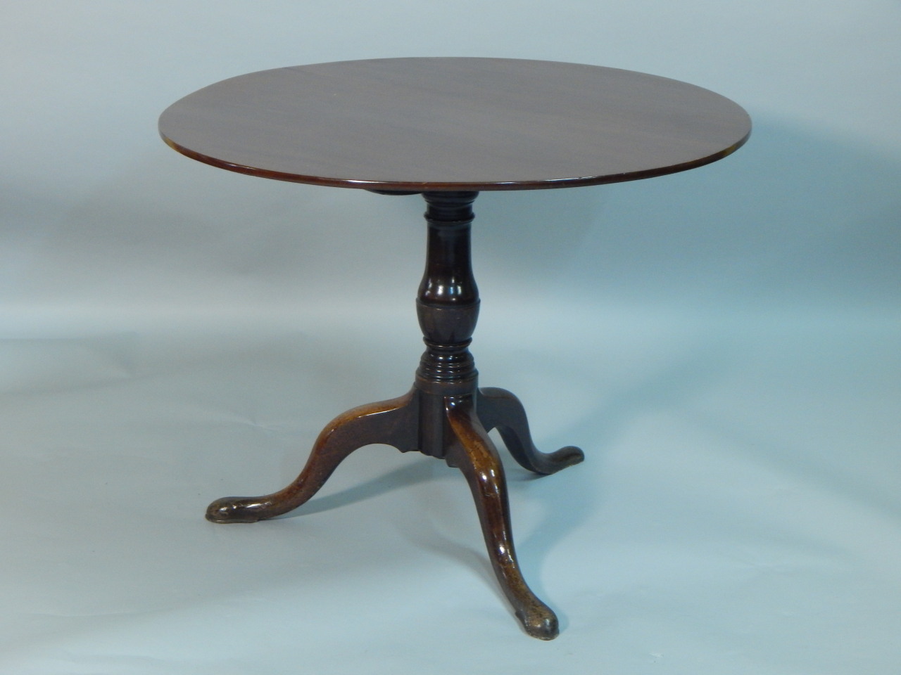 Appraisal: A George III mahogany tilt top table the circular top