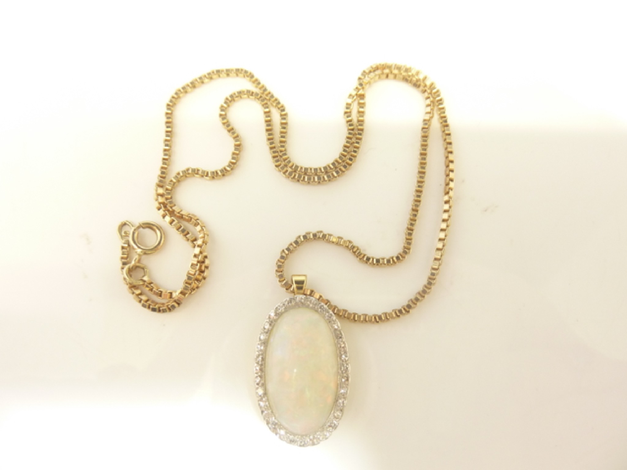 Appraisal: An opal and diamond pendant the central cabochon oval opal