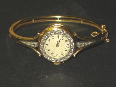 Appraisal: AN CT GOLD BANGLE WATCH the circular silvered dial with