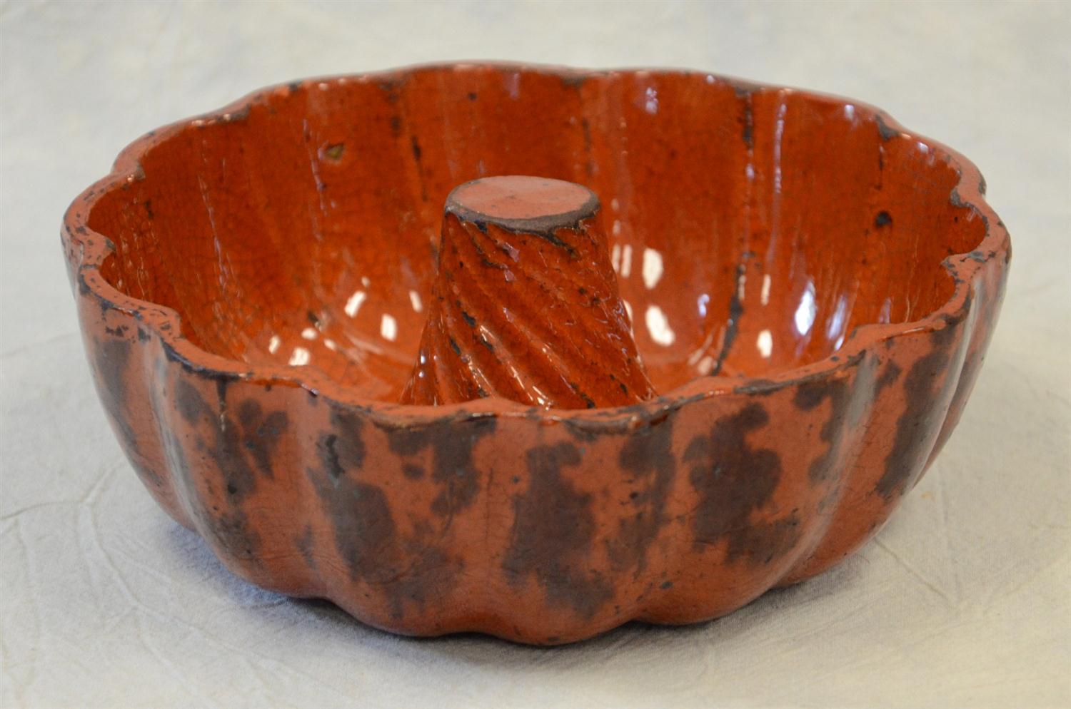 Appraisal: Redware bundt pan manganese decoration solid cone c dia x