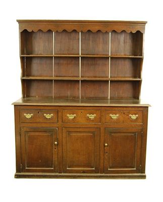 Appraisal: A th century oak dresser with a serpentine canopy frieze