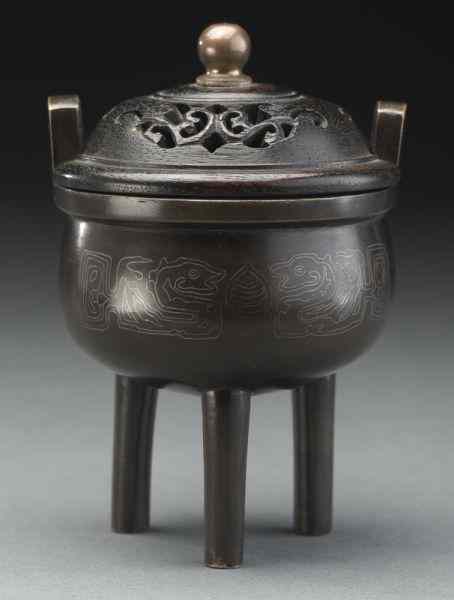 Appraisal: Chinese Qing silver inlaid bronze censerdepicting dragons and the face