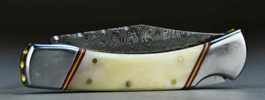 Appraisal: Damascus Blade Folding KnifeWith carved and polished bone handle fitted