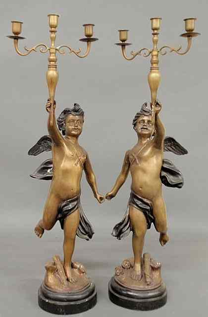 Appraisal: Pair of faux bronze metal candelabra with winged cherubs h