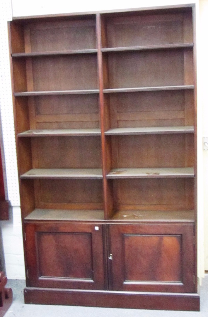 Appraisal: A th century floor standing pine and mahogany bookcase cupboard