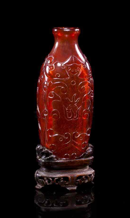 Appraisal: A Carved Amber Snuff Bottle of elongated squared form having