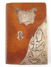 Appraisal: A leather wallet with various silver religious and secular motifs