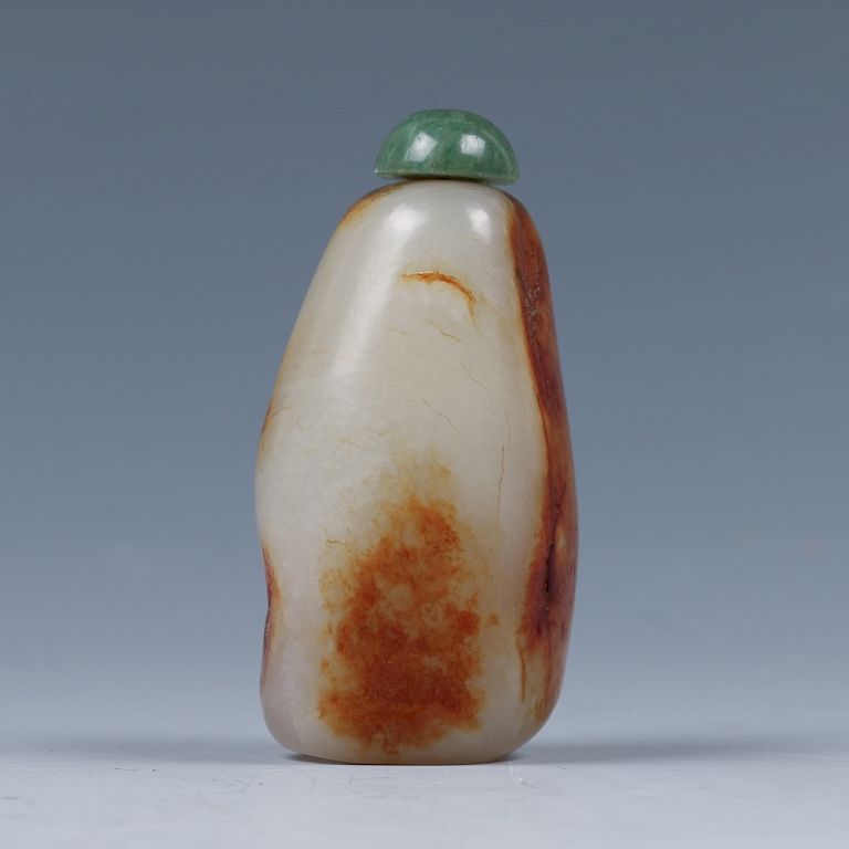 Appraisal: WHITE RUSSET PEBBLE STONE SNUFF BOTTLE QING Of irregular pebble