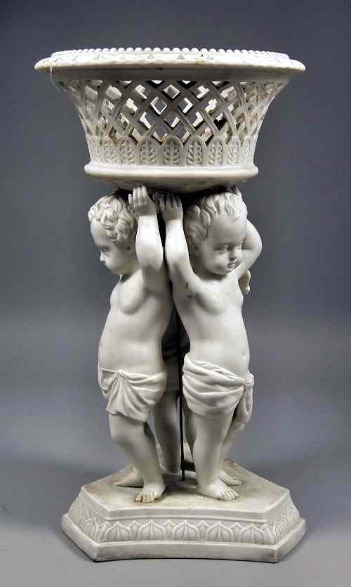 Appraisal: A th Century Parian centrepiece modelled as three putti supporting