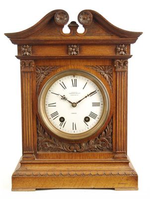 Appraisal: A carved oak cased mantel clock with an day movement