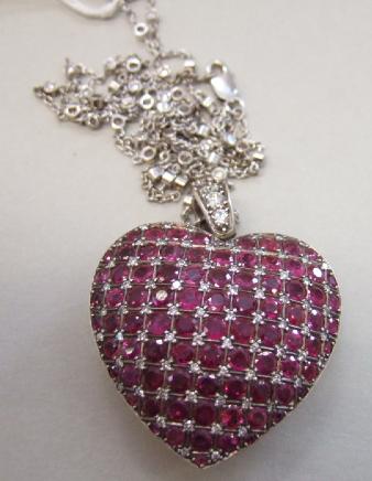 Appraisal: A ruby and diamond set heart shaped pendant pave set