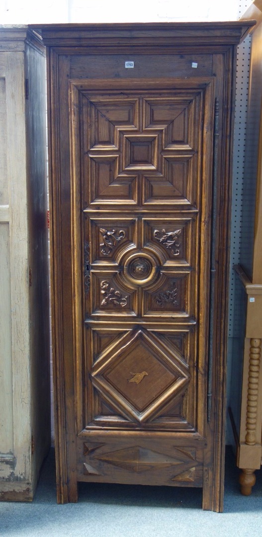 Appraisal: An early th century walnut and oak armoire with carved