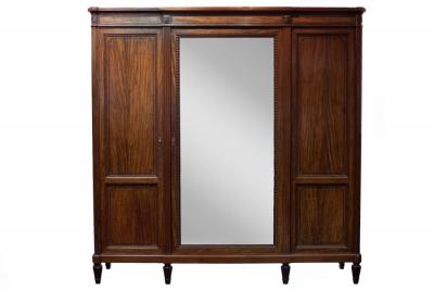 Appraisal: A mahogany Empire style wardrobe with breakfront cornice set floral