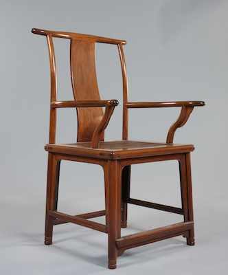 Appraisal: A Chinese Yokeback Armchair The gracefully carved wood armchair measures