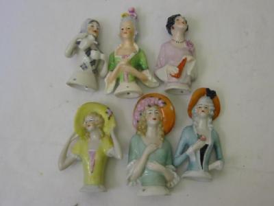 Appraisal: Six porcelain pin cushion dolls including one modelled pouring tea