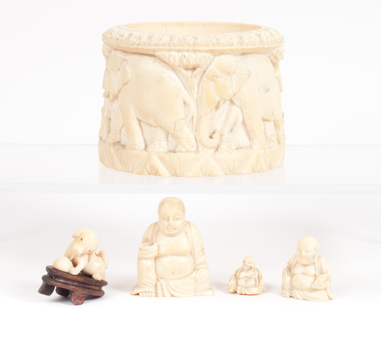 Appraisal: Five carved ivory objects including African box with elephant parade