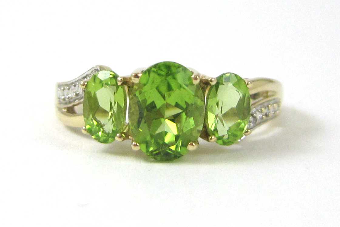 Appraisal: PERIDOT DIAMOND AND TEN KARAT GOLD RING with one round-cut