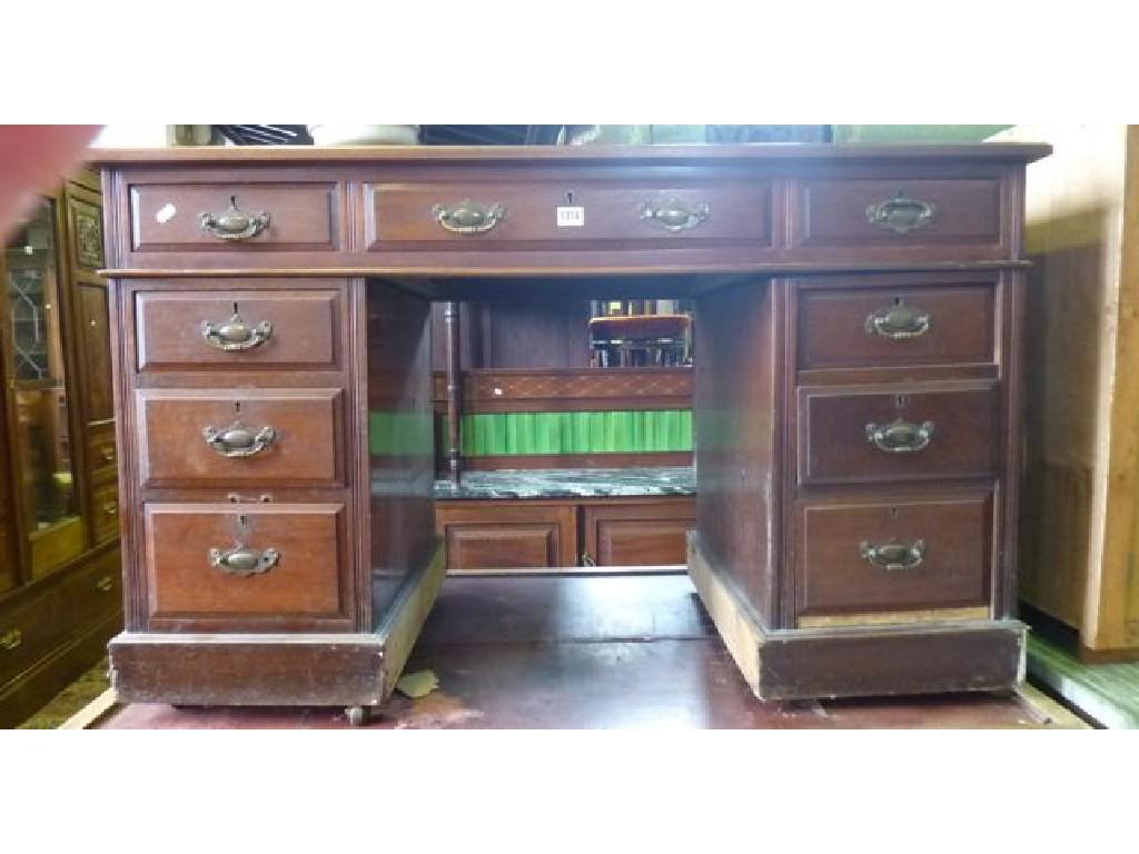 Appraisal: An Edwardian walnut kneehole pedestal desk with inset leather panelled