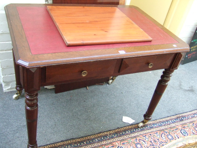 Appraisal: A Victorian walnut writing table the canted rectangular top over