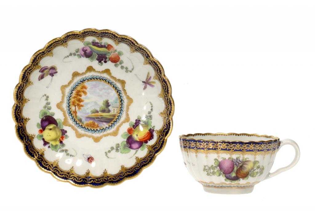 Appraisal: A WORCESTER FLUTED TEACUP AND SAUCER painted with a version