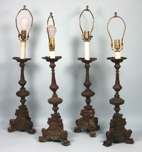 Appraisal: Four th- th Century continental embossed brass candlesticks made into