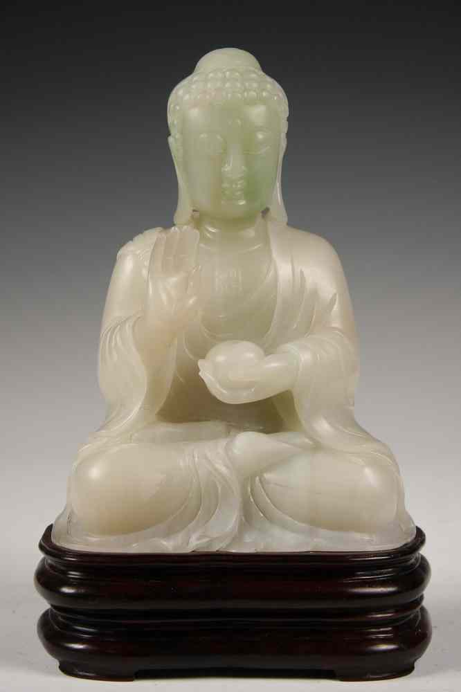 Appraisal: JADE BUDDHA - White Jade Buddha holding censer with one