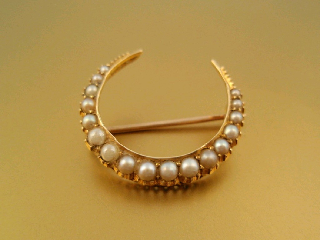 Appraisal: A Victorian seed pearl set crescent brooch