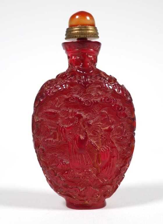 Appraisal: Intricately carved snuff bottle showing a small figure The bottle