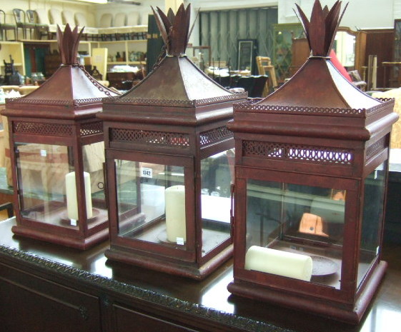 Appraisal: A set of three rouge painted tin hanging lanterns late