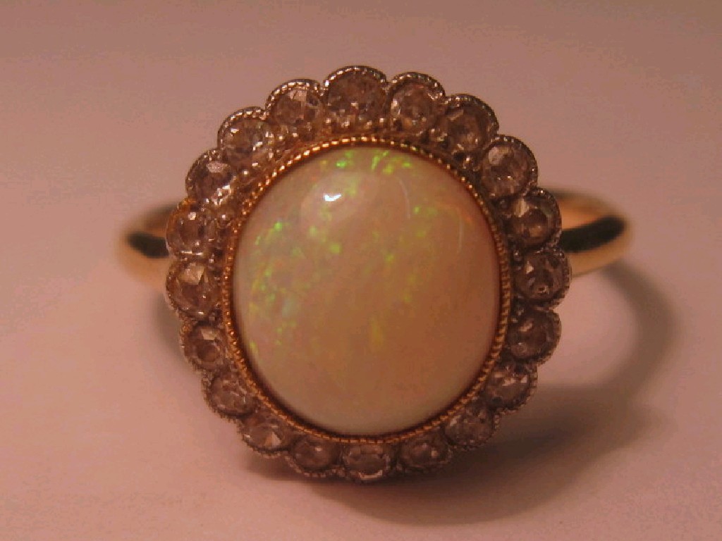 Appraisal: Eighteen carat gold opal and diamond cluster ring Circa