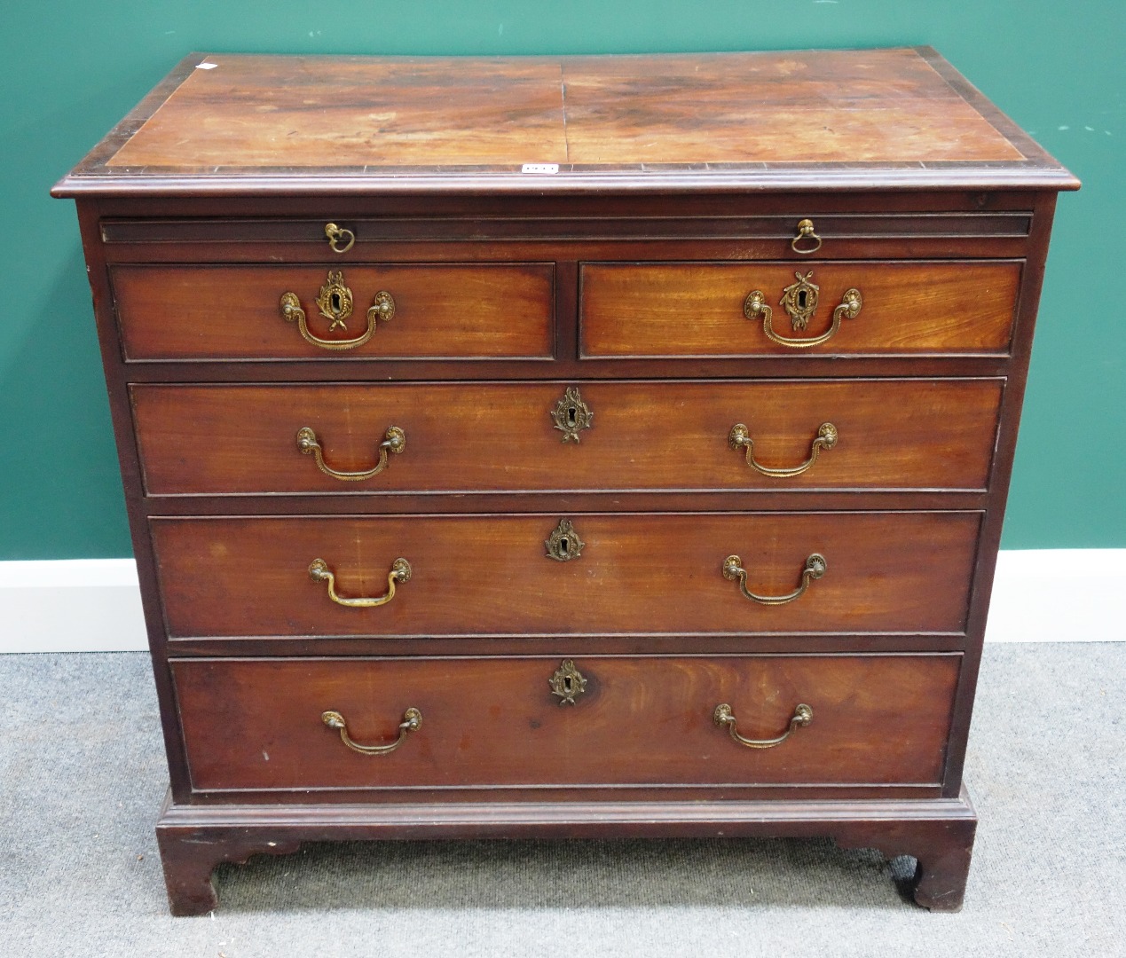 Appraisal: A George III mahogany chest with brushing slide over two