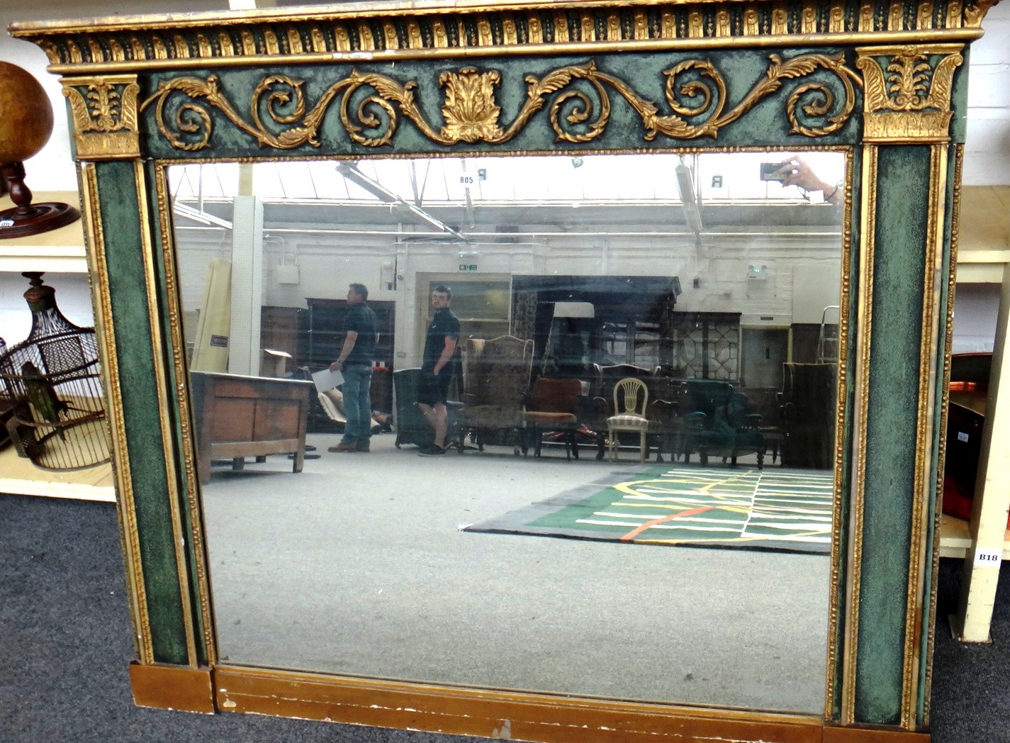 Appraisal: A th century green painted parcel gilt overmantel mirror with