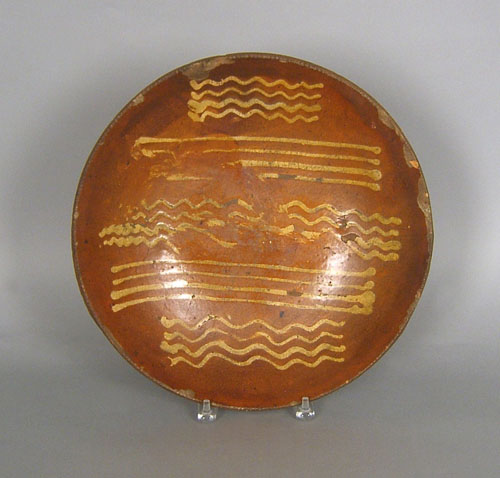 Appraisal: Redware charger th c with yellow slip decoration dia