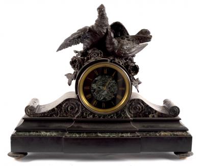 Appraisal: A black slate mounted clock with bird surmount cm wide