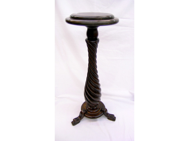 Appraisal: Mahogany footed pedestal with twist-column motif